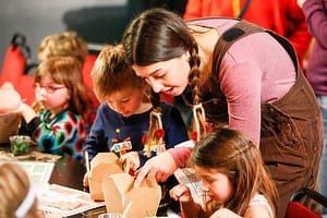 Natasha Granger helping some children at an Oskar's Amazing Adventure WorkShop Photo © Paul Mansfield