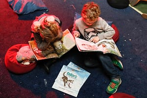 Two kids reading 'Oskar's Amazing Adventure written by Colin Granger, illustrated by Lisa Smith Photo © Paul Mansfield